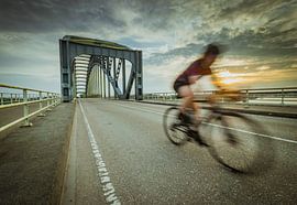 Cyclist over the Ijsselbrug by Jan Willem Oldenbeuving