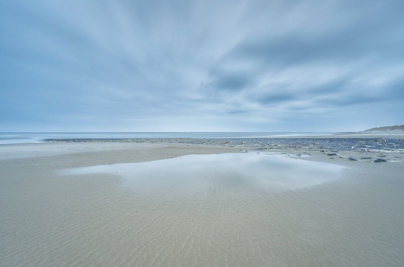 Rain and clouds above the beach by Marcel Kerdijk