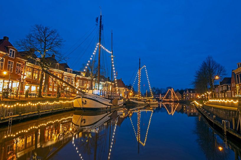 Decorated sailboats in the harbour of Dokkum in the Netherlands by evening by Eye on You
