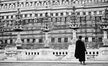 Monk standing in front of temple by Marianne Kiefer PHOTOGRAPHY
