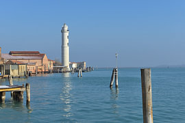 The Murano lighthouse towers high above the buildings in the Venetian Lagoon by Tomherkules