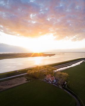 Dike house in Friesland with a beautiful sunset