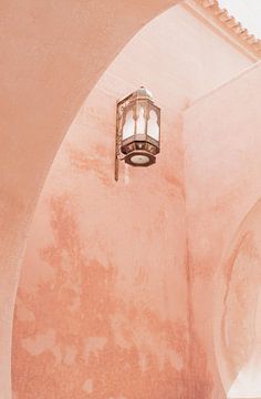 Pink wall and lantern in Marrakech by Leonie Zaytoune