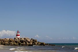 Red-white light house on the  sea dam by Irene Lommers