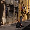 Traveler with suitcase in Sete, France by Jochem Oomen