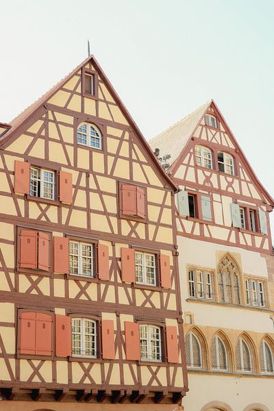 Colorful half-timbered houses in orange and rose in Colmar, Alsace region France by Anke Sol