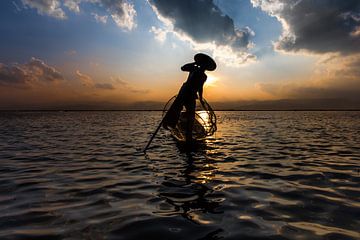 Fisherman with traditional boat on the Inle lake in Myanmar. It is a traditional but very old-fashio by Wout Kok