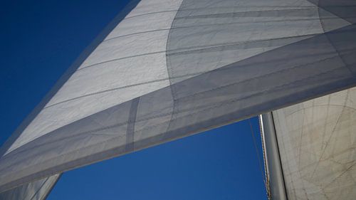 White sail against blue sky