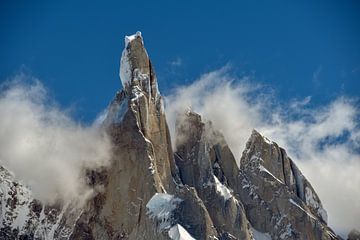 Mystic mountain: summit of Cerro Torre in patagonia surrounded by clouds by Christian Peters