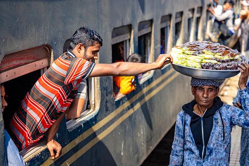 Boy leans out of train and grabs candy by Steven World Traveller