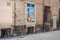 Een fiets en een engel tegen een oude Franse gevel
