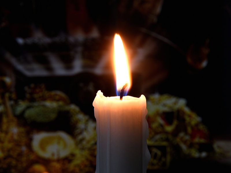 Burning candle on dark background by Karel Frielink