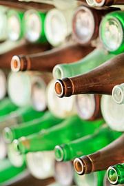 Wall made of empty red and green beer bottles  by Tony Vingerhoets