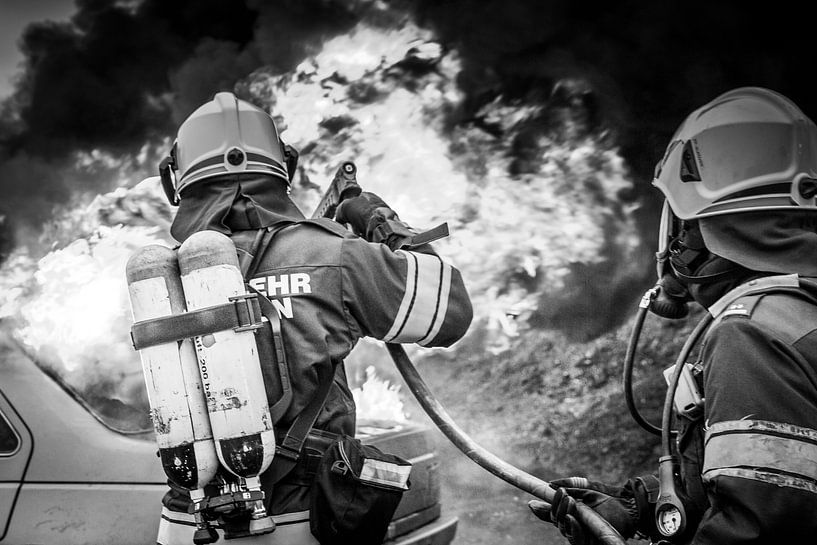 Firemen extinguish car fire by Hermann Kollinger