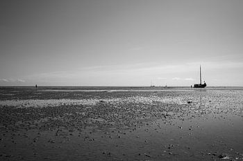 View on sea with mudflats and boat.