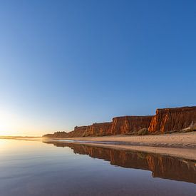 Sunset on the sandy beach Praia da Falésia. Cliffs Pink flowers near Albufeira, Portugal by Fotos by Jan Wehnert