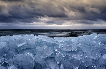Berge mit Eisblöcken und dramatische Himmel.