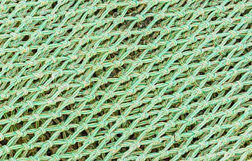 Close-up of fishing nets pattern background by Alex Winter