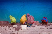Sari-clad Indian women take a bath in Varanasi, India