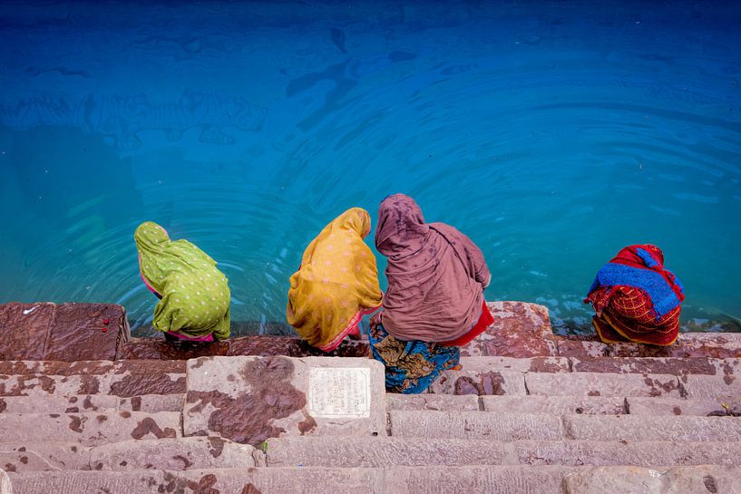 Sari-clad Indian women take a bath in Varanasi, India by Wout Kok