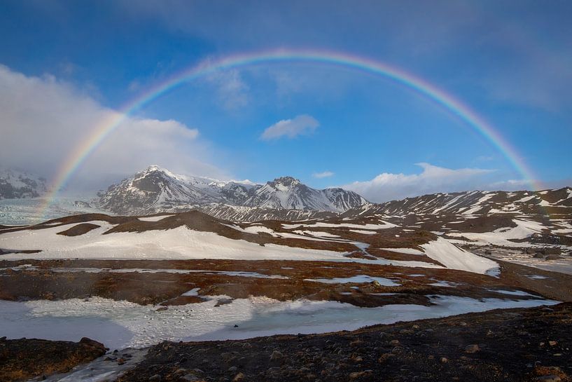 Rainbow over the mountains in Iceland by Lisa Groothuis