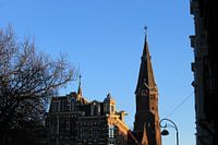 Church in Amsterdam with blue skies and orange glow evening