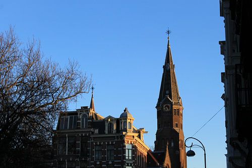 Church in Amsterdam with blue skies and orange glow evening