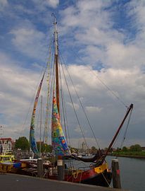 Sailboat with colorful sails in the harbor of Zierikzee by tiny brok