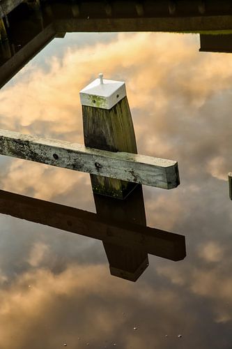 Lake pole in a reflection of the clouds sky in the water. One2expose Wout Kok Photography