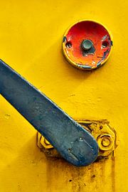 Push button and lever on a yellow locomotive by Jenco van Zalk