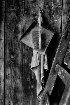 Dustpan and brush, towel and ladder against a wooden wall. van JRobert Photography