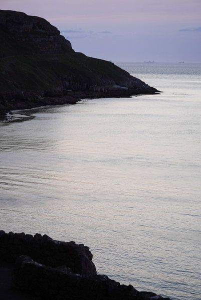 A harsh contrast of rocks and sea at sunset by Aron.jpg
