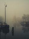 Montelbaans toren in de mist #1 van Roger Janssen thumbnail