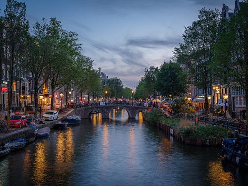 De mooie grachten van Amsterdam in de avond tijdens het blauwe uur met reflecties