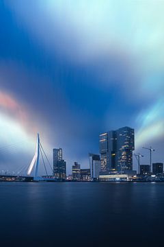 City view of Rotterdam and the Erasmus Bridge taken on a rainy evening in Rotterdam Netherlands.