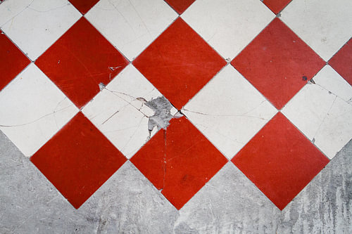 Red and white tiled floor with cement