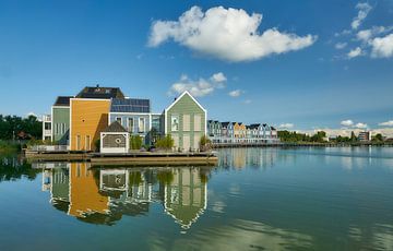 Reflections of coloured houses on the Rietplas lake by Ad Jekel