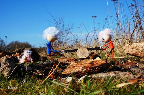 Fubby's sawing through trunk of tree.