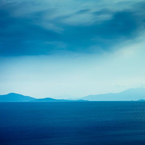 View from the greek peninsula Pilion on the island Evia under a rainy sky