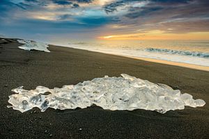 Ice shape washed up on a black beach in Iceland