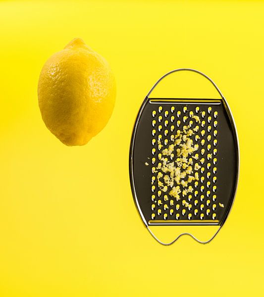 Lemon, grater and zest on yellow by Wim Stolwerk