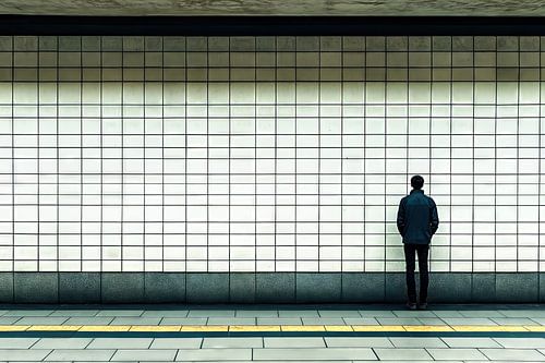 Jeune homme dans une station de métro vide