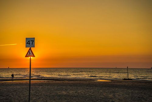 Beach with sun blocked by sign