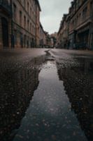 Reflection in a puddle of an idealistic French city