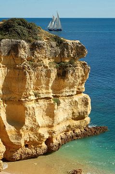 Algarve rock and sailing boat by insideportugal