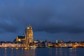 Dordrecht skyline featuring the Grote Kerk during the blue hour with threatening skies by Mark den Boer