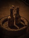 Twee oude flessen op Biervat van Arnold de Gans thumbnail