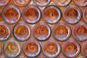 Orange colored, reclining wine bottles