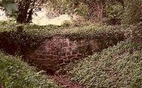 A rustic old bridge over a stream