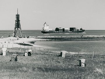 Kugelbake and container ship in Cuxhaven - black and white by Werner Dieterich
